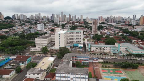 aerial rotates above campo grande cityscape skyline in brazil, overcast