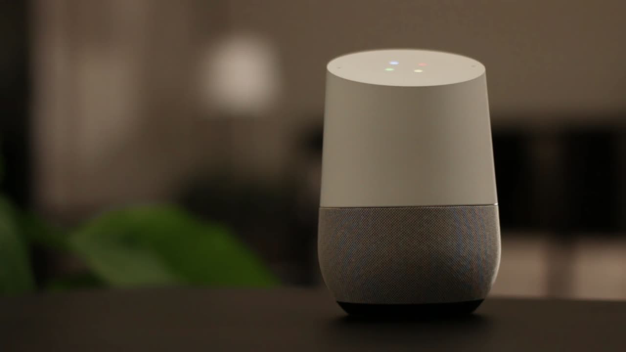 Voice controlled speaker turns on a light in a smart home at night