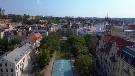 aerial view of a european city with a park and fountain