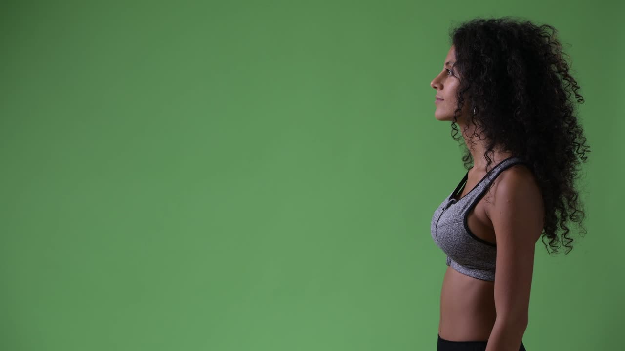 Profile view of young happy beautiful Hispanic woman ready for gym