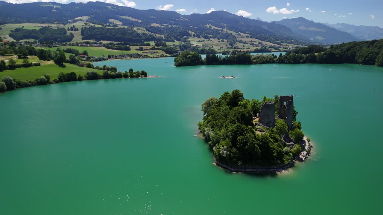 Le Bry island Lake Gruyère Switzerland aerial drone ruined castle church turquoise blue color