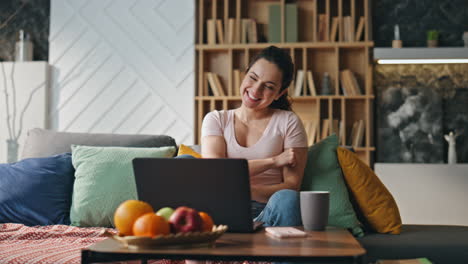 woman winner rejoicing success looking on laptop at home. girl feeling happy