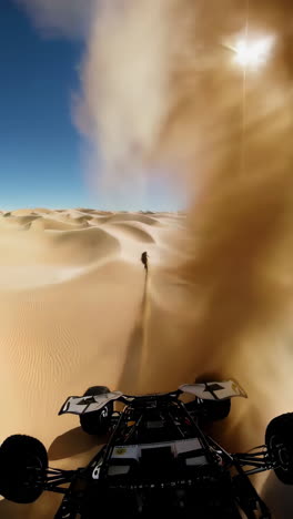 atv driving through sand dunes