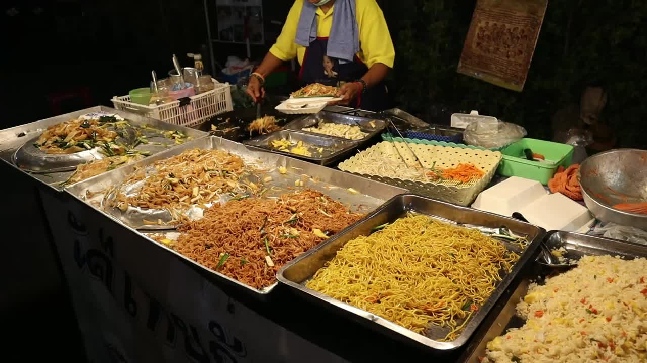 Popular Saturday Night Market Street Food in Chiang Mai, Thailand. Pad Thai and noodle street food made with fresh. A lively and fun night market
