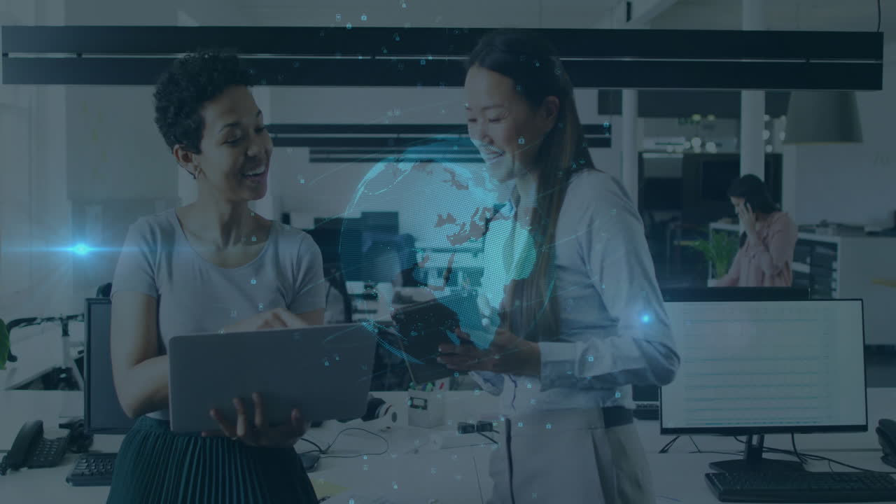Two women collaborating in office with digital globe animation overlay