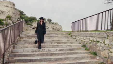 elegant woman on high heels walking down the stairs of the town square