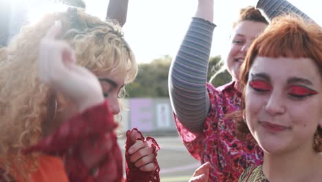 happy young people dancing outdoor at festival event - party and entertainment concept