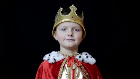 Young boy dressed as a king or prince in a royal costume