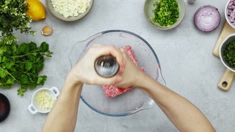 crop person adding spices into minced meat