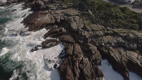 Ocean-Waves-Crashing-On-Rocky-Coast-Of-Beach-On-A-Sunny-Day