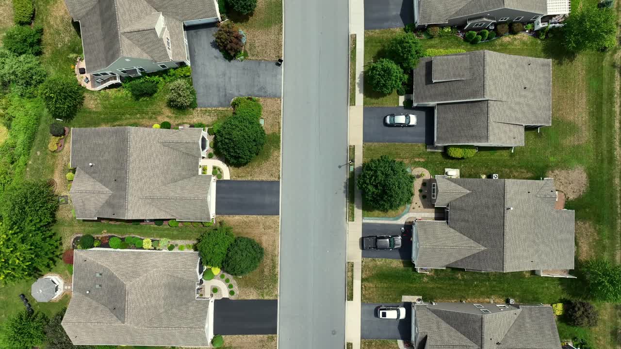 Aerial View of a Suburban Neighborhood Street with Houses and Cars