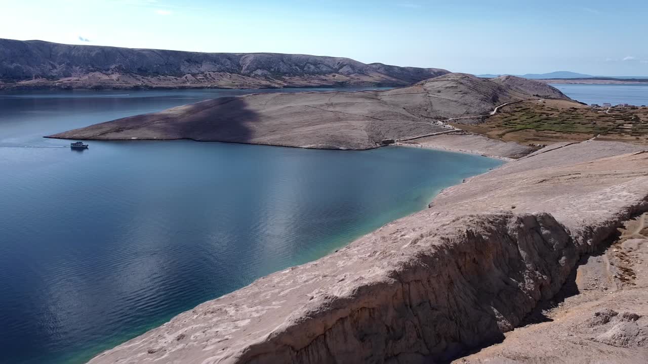 Drone fly through rocky mountains, revealing the coast