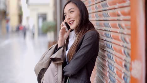 young woman talking on her mobile in town