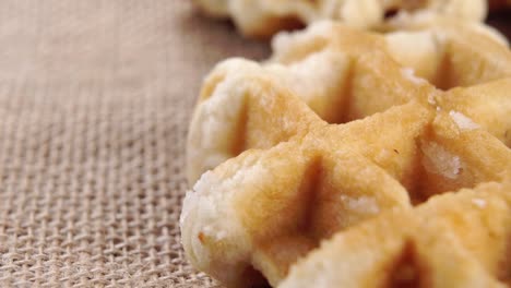 brussels soft waffles on a rough rustic burlap. macro