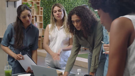 multi ethnic business women meeting brainstorming together team leader woman sharing creative ideas planning development strategy using laptop technology in modern office workplace