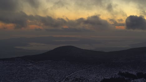 aerial - flying near the clouds at dusk over snowy mountains - shot on dji inspire 2 x7 50mm raw