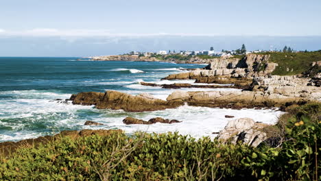 windy weather on rocky coastline as waves roll in, walker bay, hermanus