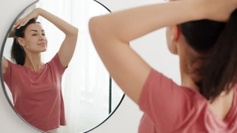 mujer preparándose frente a un espejo