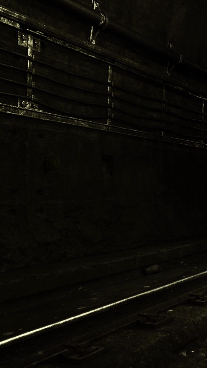 Train tracks in a dark underground tunnel near a city subway station