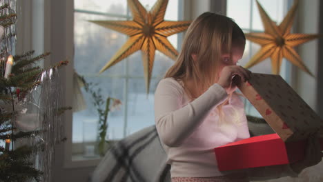 a blonde girl opens a magic light box