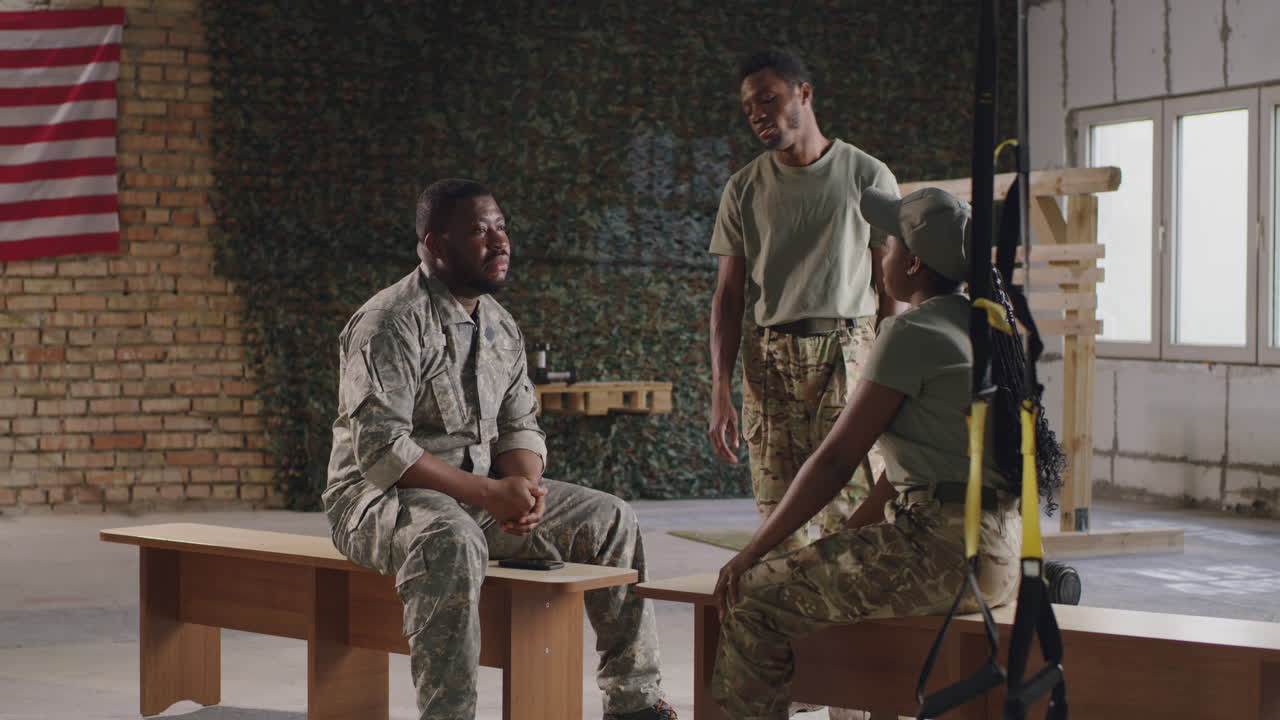 Military personnel having a conversation in a training facility