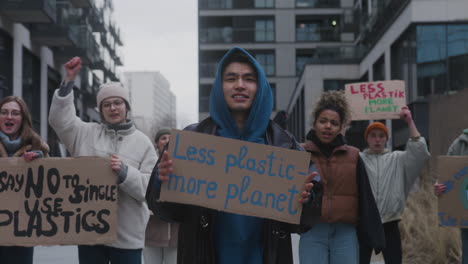 group of young activists with banners protesting against climate change in the city 1