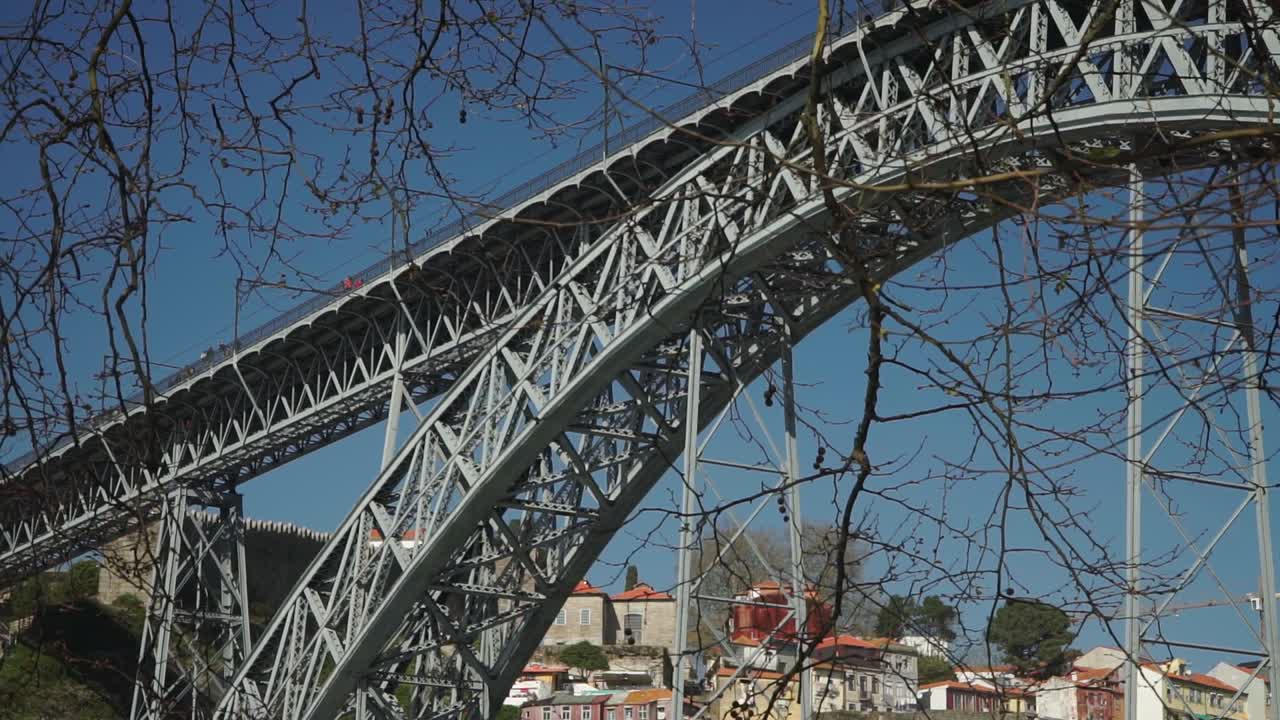 Truck Right to Left shot, Tree branches with twigs, Scenic view Dom Luis Bridge in Porto Portugal in the background