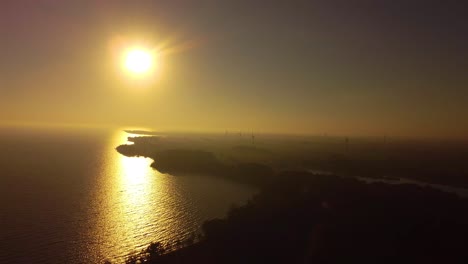 yellow sunflare sunburst seaside with windmills electricity wind generators