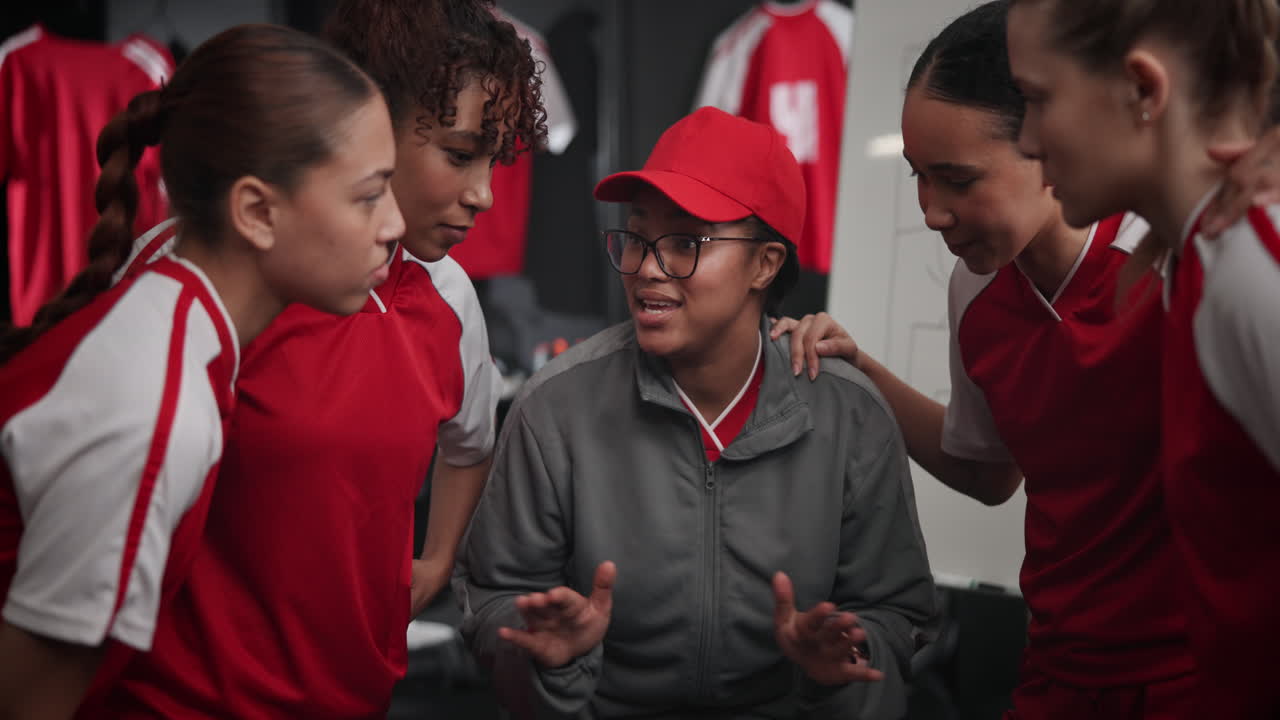 Female Athletes with Coach in Locker Room