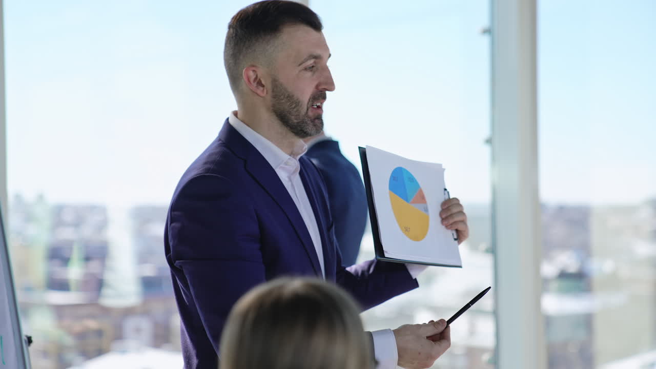 Team leader explaining diagram and employees commenting. Collaboration and teamwork during business meeting.