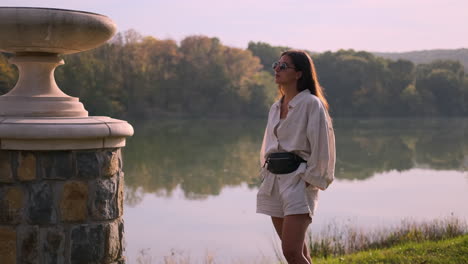 woman by the lake at sunrise/sunset