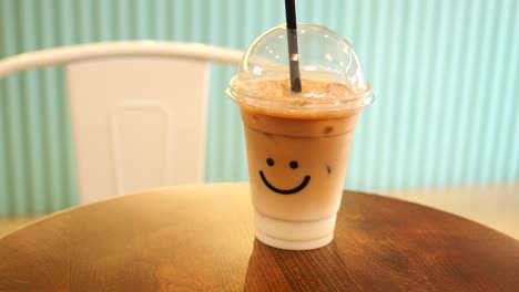 iced coffee in plastic cup with smile