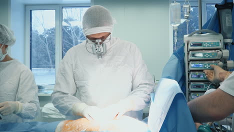 surgeon massages patient chest in room. surgeon in latex gloves checks body before coronary artery bypass surgery in hospital. cardiac medical service