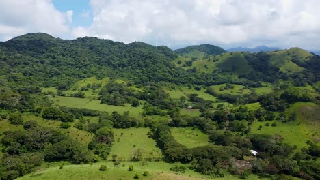 Aerial-forward-shot-of-green-mountains-with-fields-in-Rainforest-area-of-,-Yucatan's-,-México