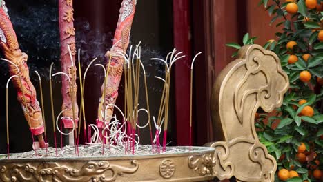 incense sticks burning in ornate holder