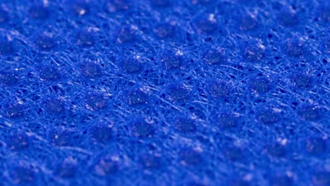 blue textile cloth surface texture, macro shot close up view with rotation motion