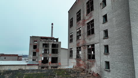 industrial zone premises being ruined with time. old buildings with broken windows ready to be demolished.
