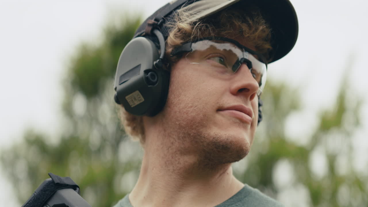 Man with rifle wearing hearing and eye protection