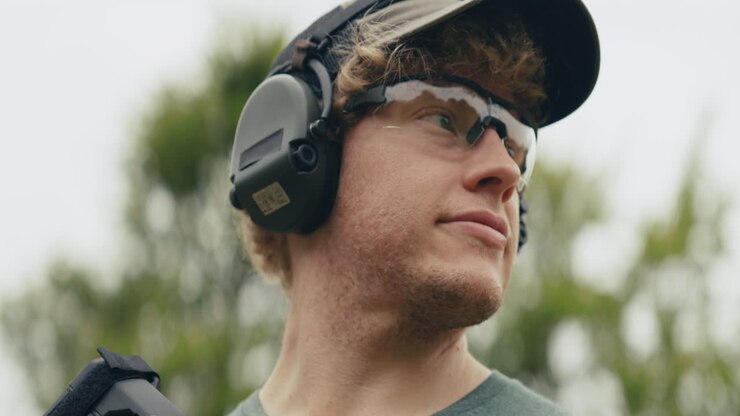 Man with rifle wearing hearing and eye protection