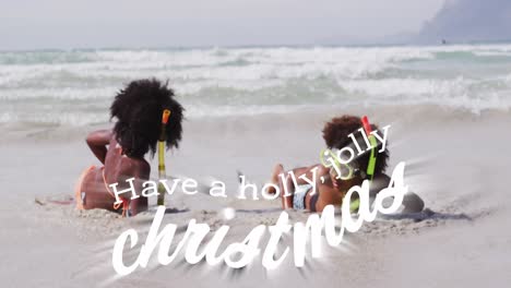 Animation-of-have-a-holly-jolly-christmas-over-happy-african-american-children-on-beach