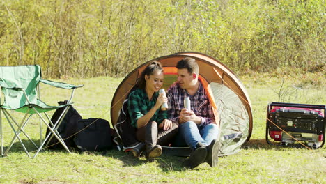 beautiful couple having a conversation in camping tent