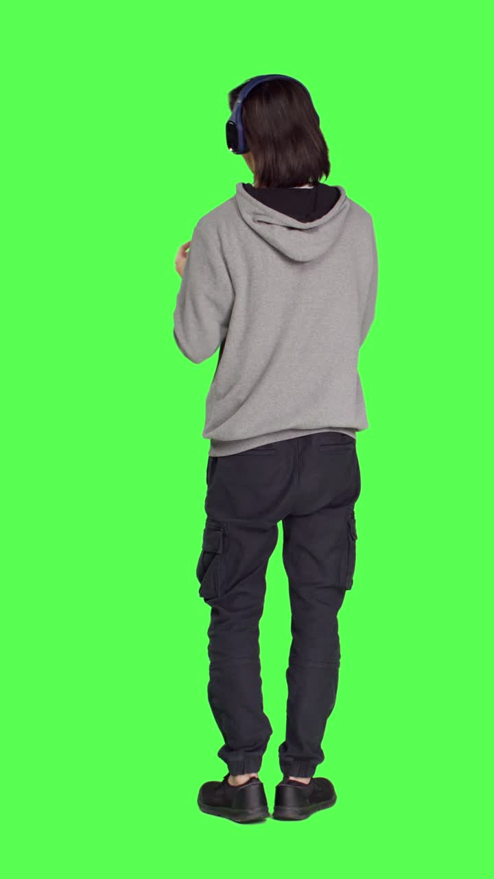 Back view of joyful man does groovy dance moves
