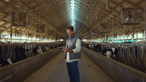 Farm-engineer-work-cowshed-holding-clipboard.-Businessman-check-animals-closeup