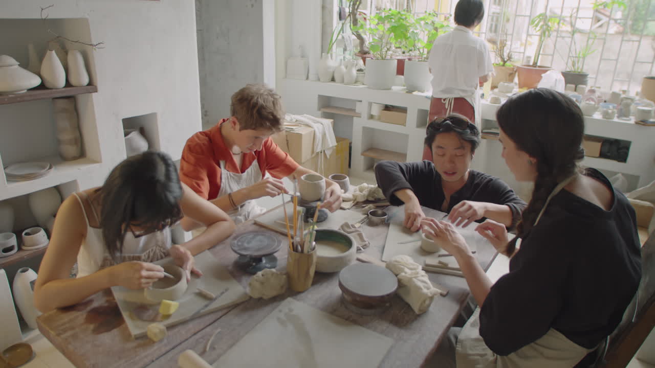 Group of Students Learning Pottery with Teacher at Masterclass