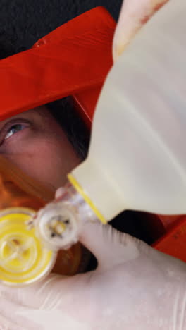 emergency medical technician placing an oxygen mask