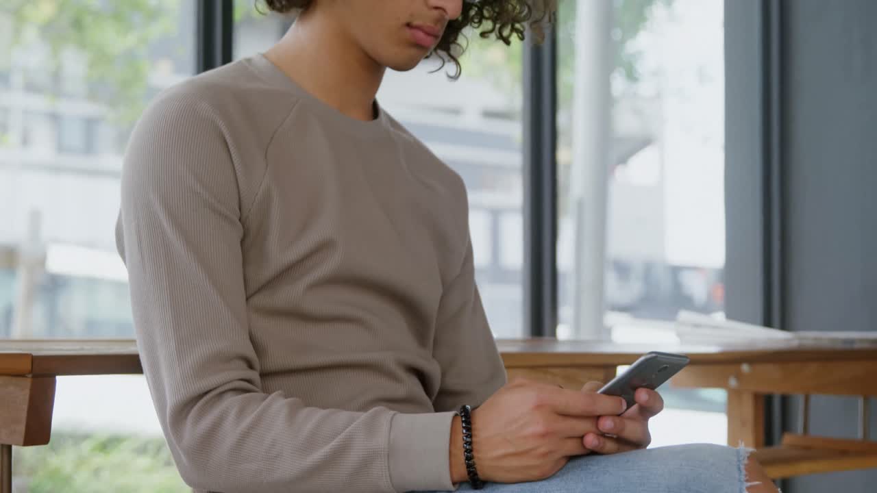Man using mobile phone in coffee shop 4k