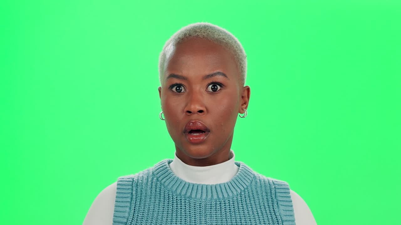 A surprised woman on a green screen
