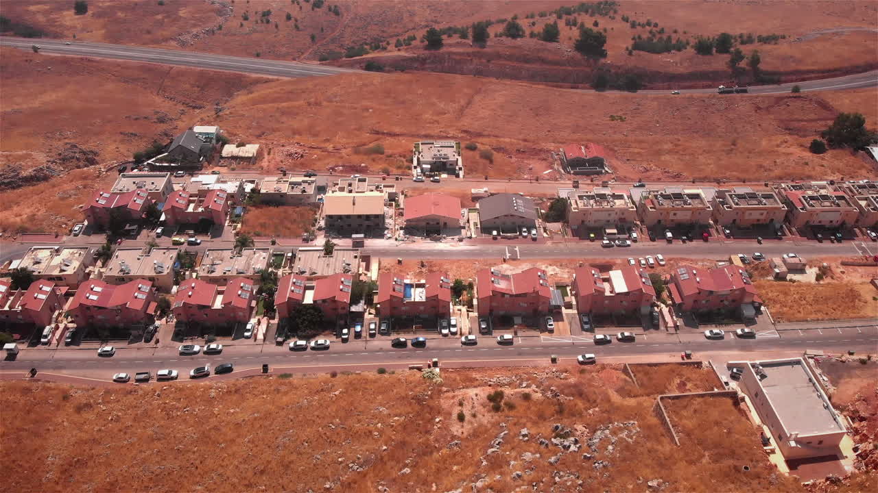 Small Village with red rooftops in the desert Heat Aerial