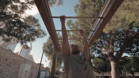 a young man doing a monkey bar walk