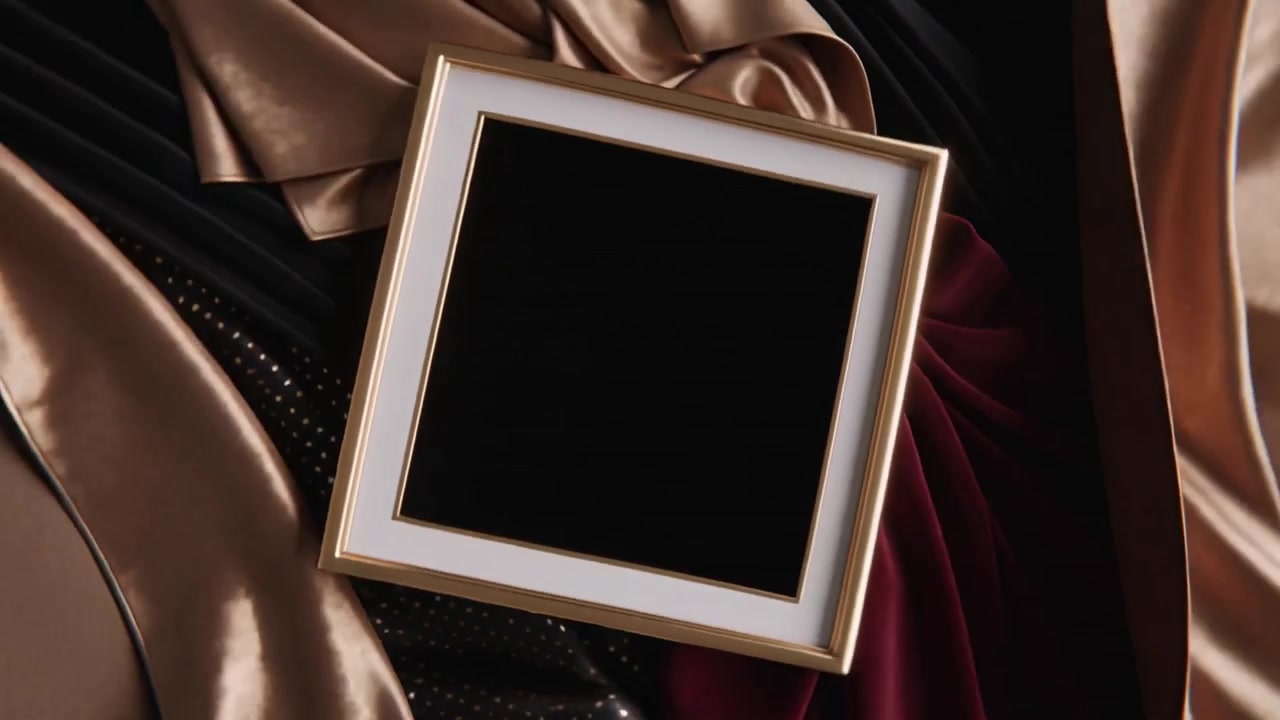 Revealing gold trim square box resting on studio set, subtle motion switching insert showing finish